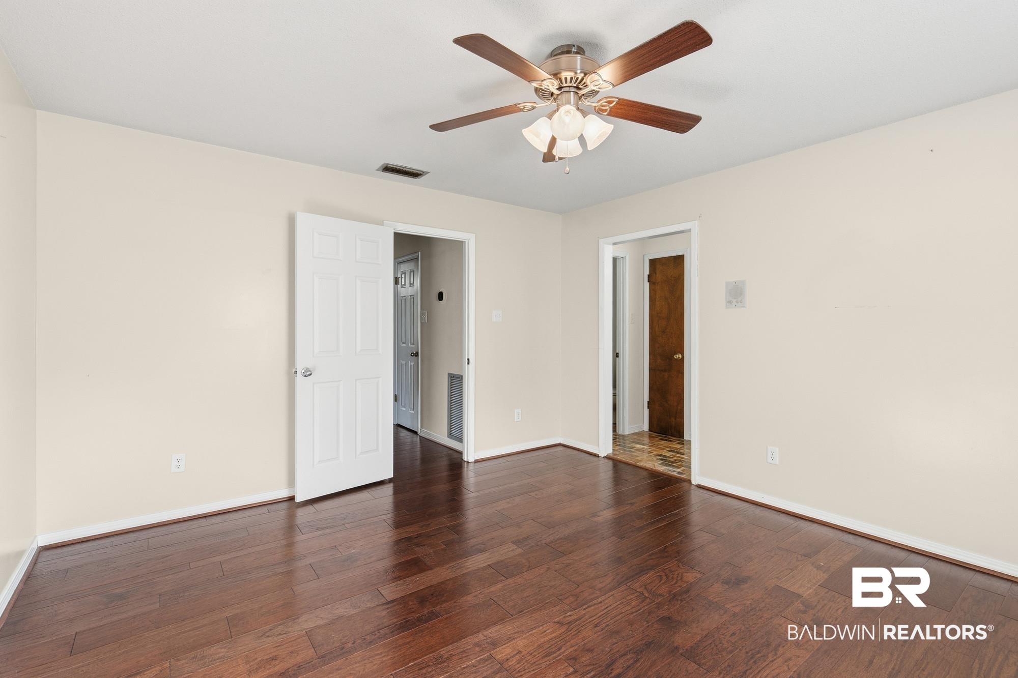 9215 Shiloh Drive Mobile, AL 36695 - Photo 22 of 32 Spare room featuring dark wood-style floors and a ceiling fan
