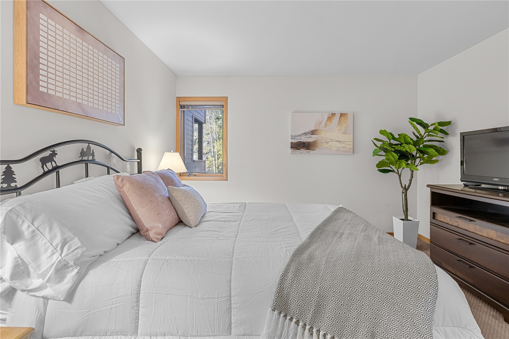 22804 Highway 6, Unit 102 Keystone, CO 80435 - Photo 20 of 34 a bedroom with a bed potted plant on dresser and a window