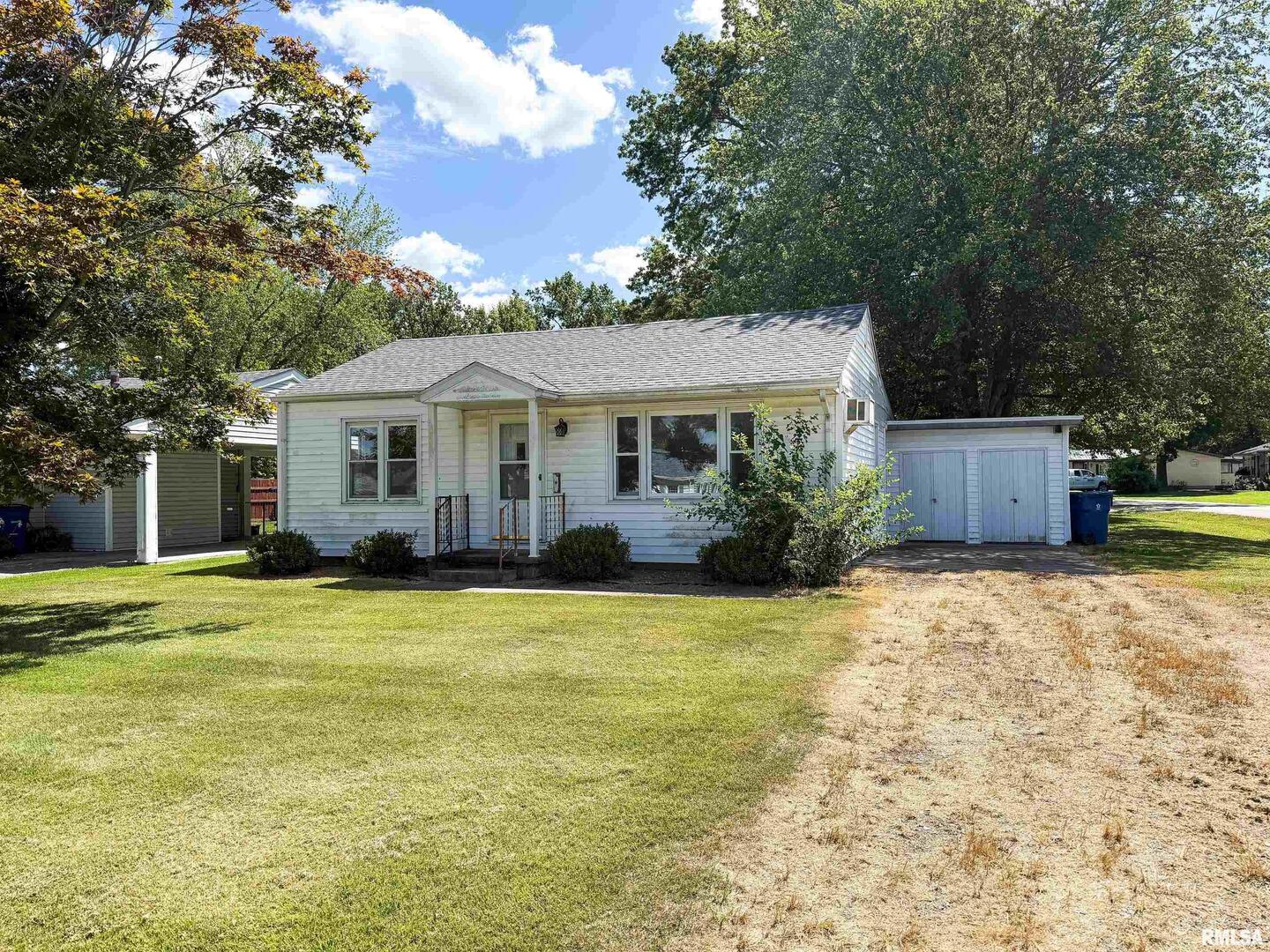 225 Hickory Street Flora, IL 62839 - Photo 1 of 56 a front view of a house with a garden