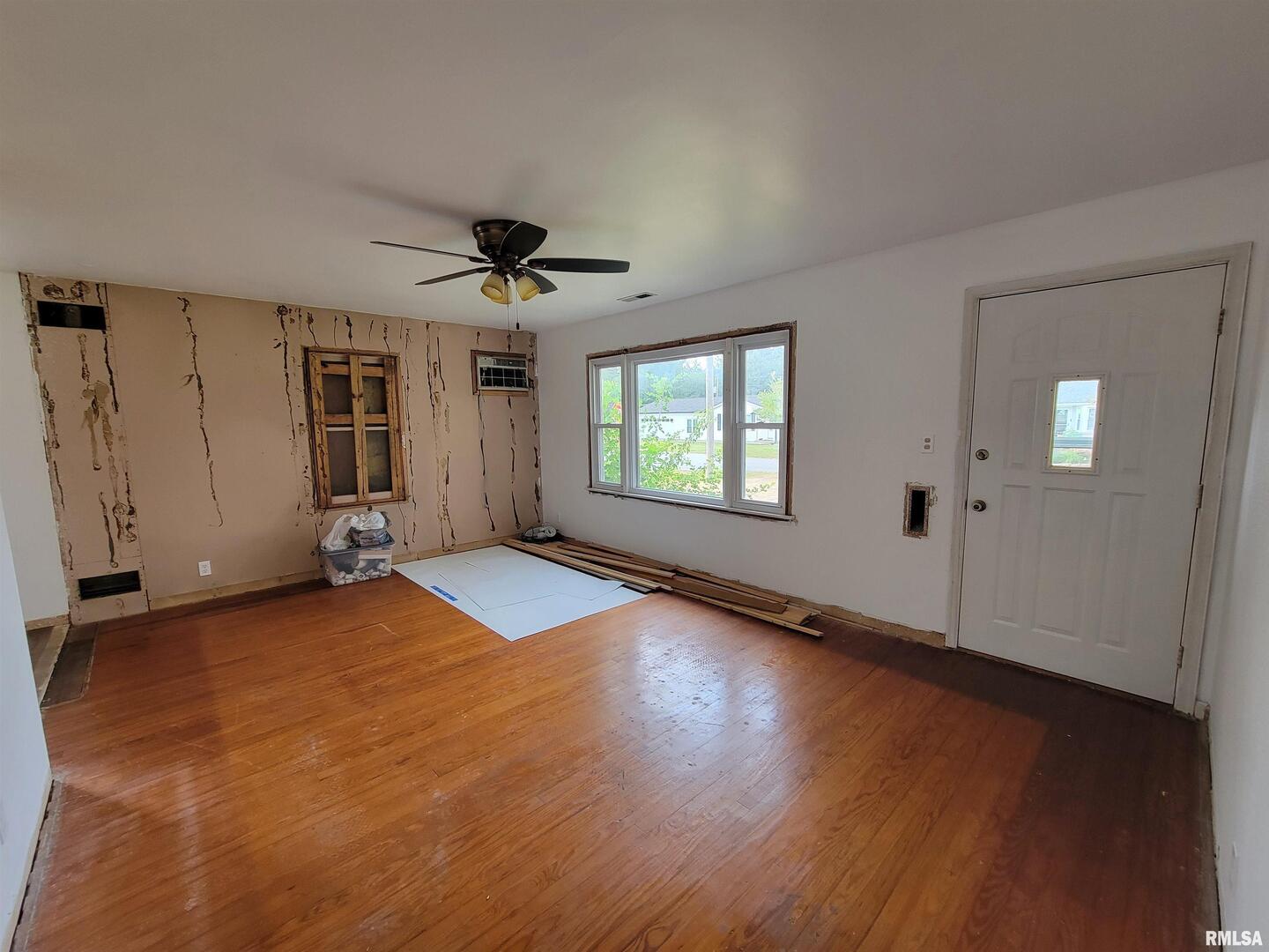 225 Hickory Street Flora, IL 62839 - Photo 16 of 56 an empty room with wooden floor and windows