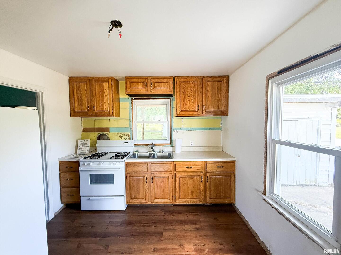 225 Hickory Street Flora, IL 62839 - Photo 23 of 56 a kitchen with a stove a sink and a refrigerator