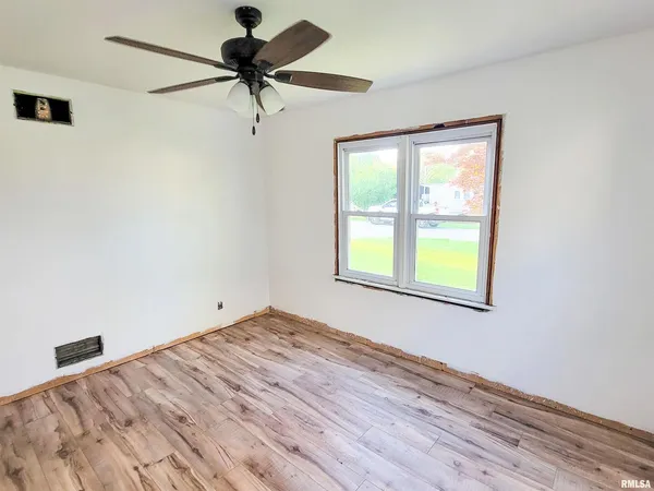a view of a room with a window and wooden floor