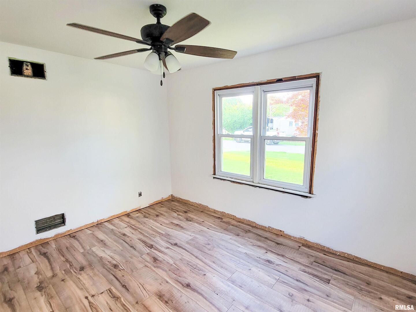 225 Hickory Street Flora, IL 62839 - Photo 3 of 56 a view of a room with a window and wooden floor