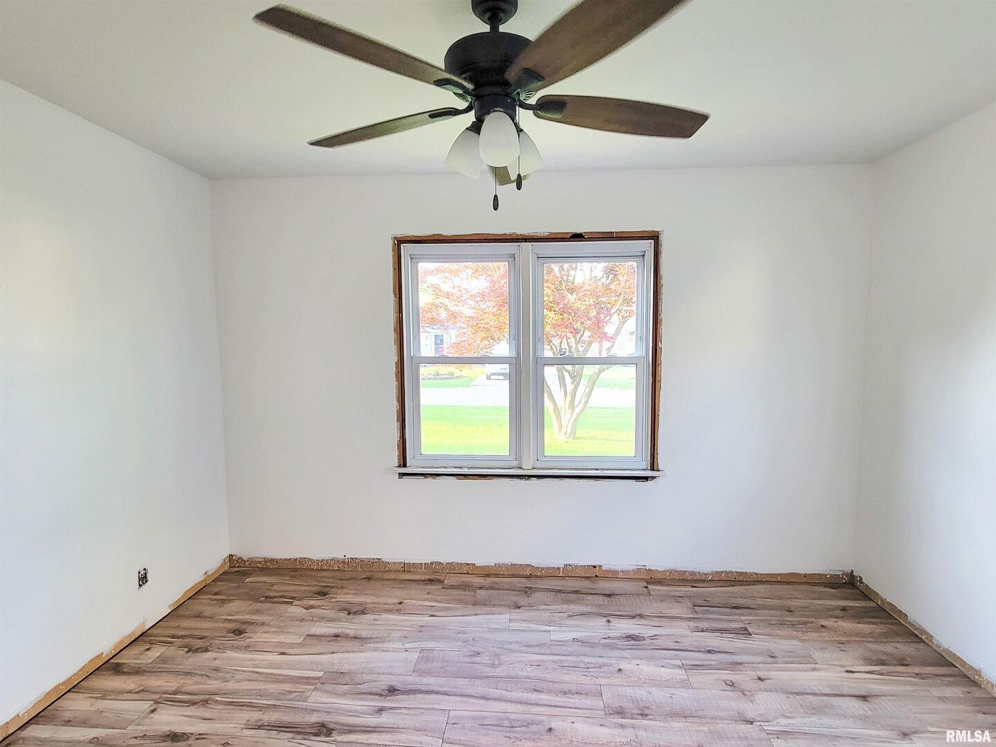 225 Hickory Street Flora, IL 62839 - Photo 31 of 56 a view of an empty room with window and wooden floor