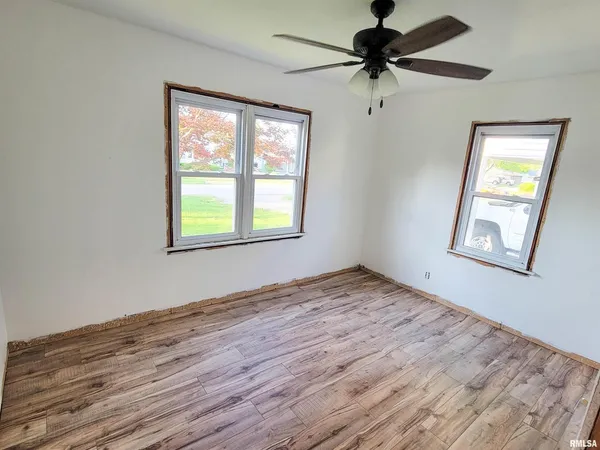 a view of a room with a window and a ceiling fan