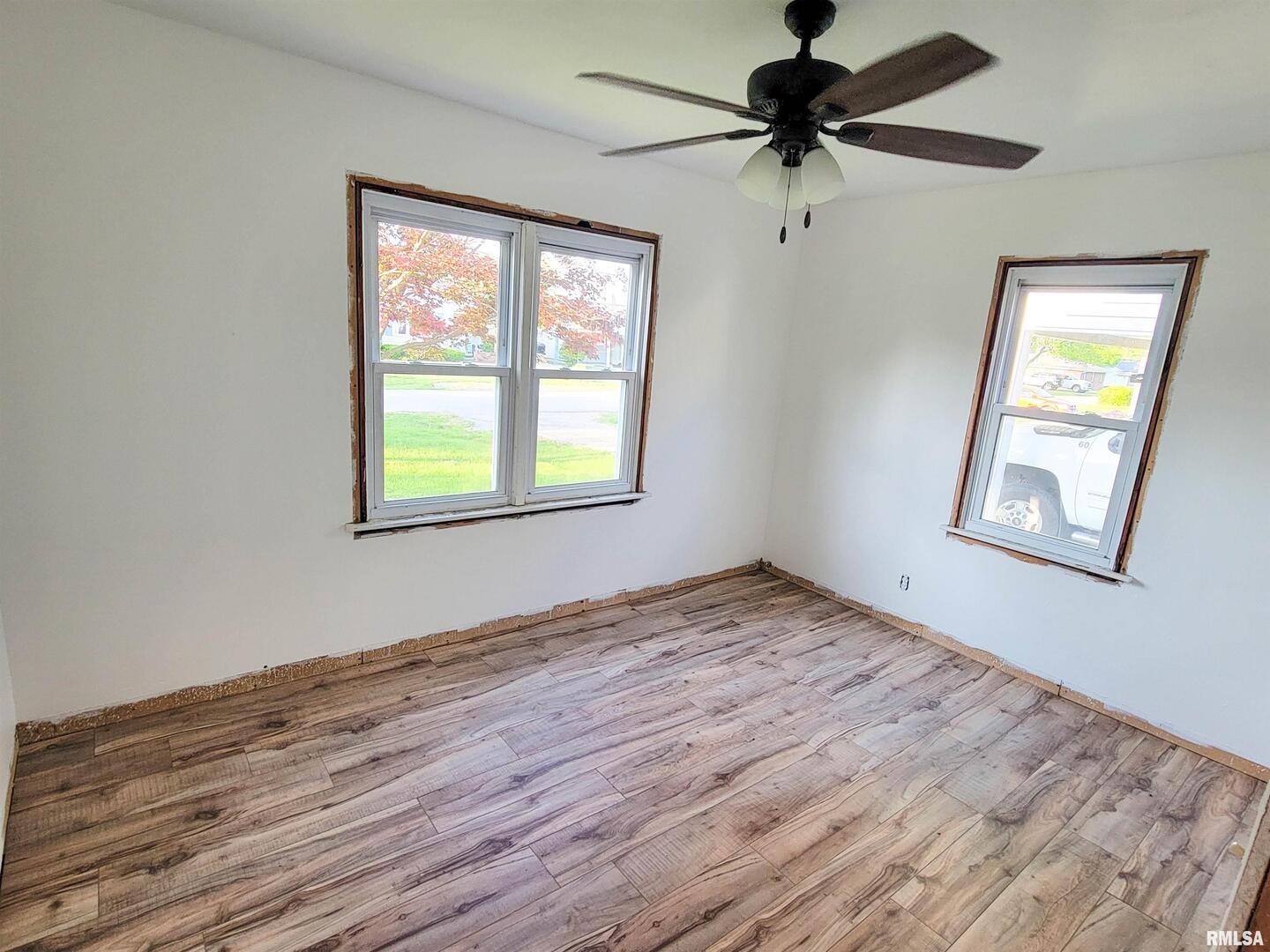 225 Hickory Street Flora, IL 62839 - Photo 32 of 56 a view of empty room with wooden floor and fan