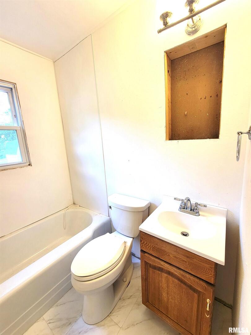 225 Hickory Street Flora, IL 62839 - Photo 40 of 56 a bathroom with a sink a toilet and shower