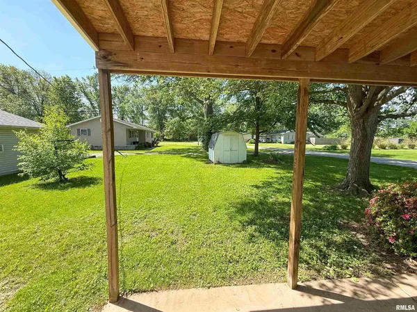 a view of a house with a yard and wooden fence