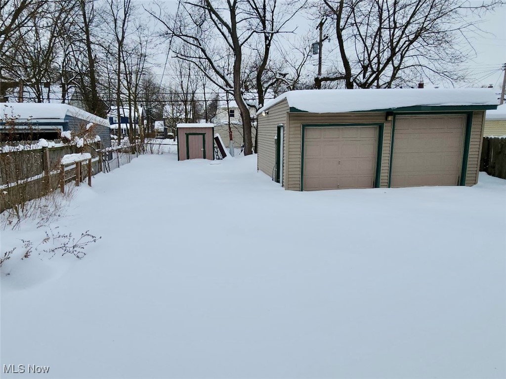 1076 Rushleigh Road Cleveland Heights, OH 44121 - Photo 24 of 27 Snowy yard with a shed and a detached garage