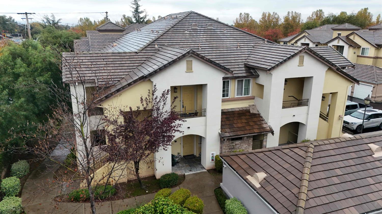 a front view of house with yard and trees in the background