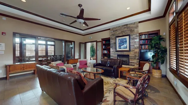 a living room with fireplace furniture and a large window