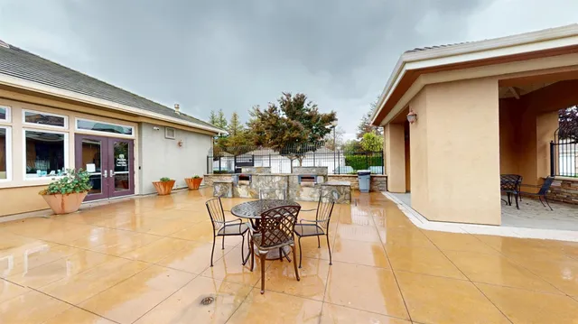 a view of a patio with dining table and chairs