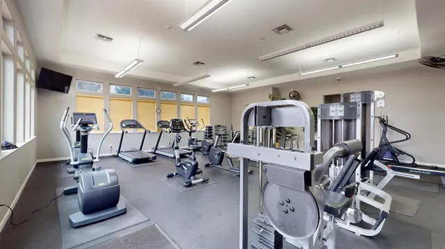 a view of a swimming pool with a bench and tables