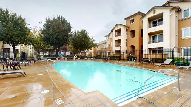 a kitchen with stainless steel appliances granite countertop a sink and a stove