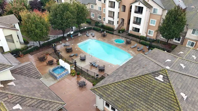 an aerial view of a house with garden space and trees
