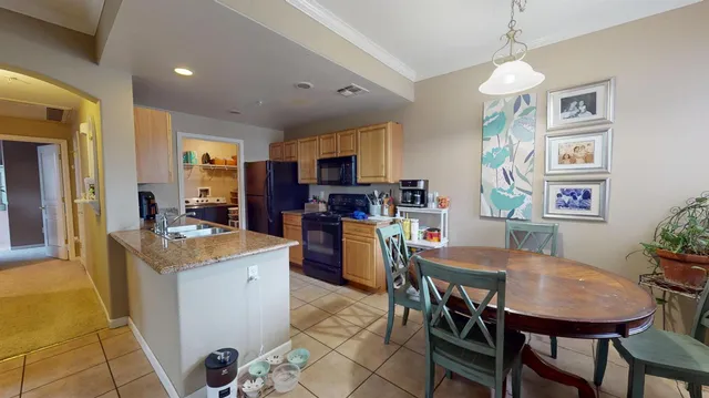 a kitchen that has a table and chairs in it