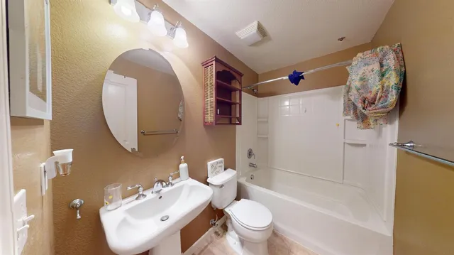 a bathroom with a sink mirror toilet and bathtub