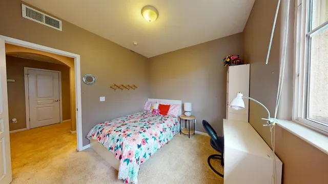 a bedroom with bed and window