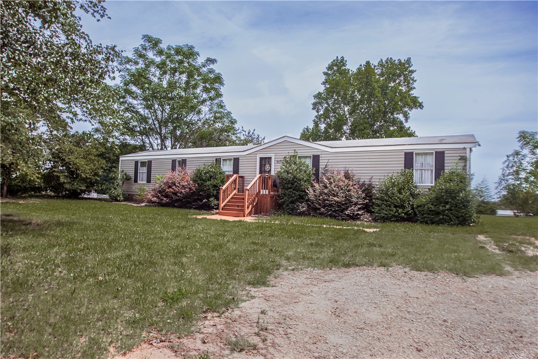 169 West Bagwell Road Liberty, SC 29657 - Photo 2 of 29 A well-maintained manufactured home nestled amidst mature trees offers inviting curb appeal.