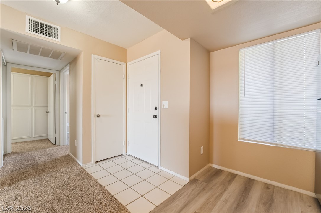 8070 West Russell Road, Unit 2024 Las Vegas, NV 89113 - Photo 4 of 19 A well-lit entry hall with mixed flooring welcomes you into the residence.