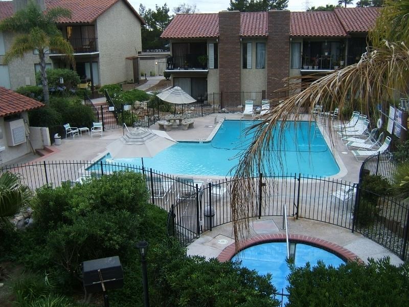 1925 Alga Road Carlsbad, CA 92009 - Photo 1 of 1 a view of a patio with table and chairs under an umbrella with a small yard