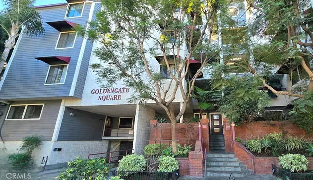 a front view of a multi story building with yard