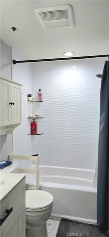 a bathroom with a shower and a toilet