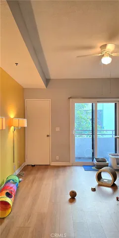 a view of a room with gym equipment and a large window