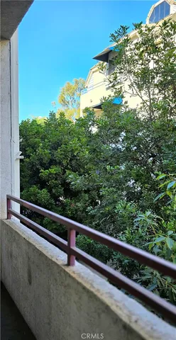 a view of a balcony with yard