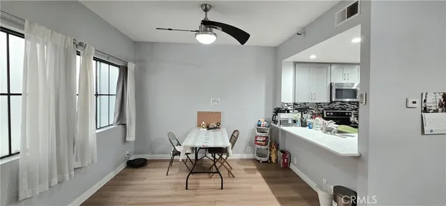 a dining room with wooden floor and furniture