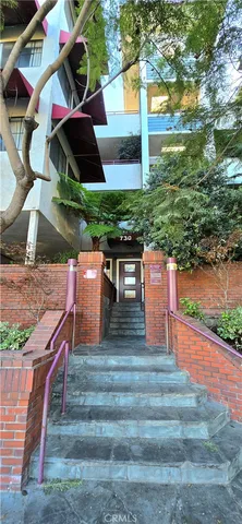 a kitchen with a refrigerator and a stove top oven