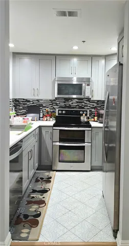 a kitchen with a stove and a refrigerator