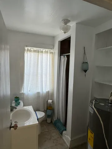 a bathroom with a sink toilet and shower