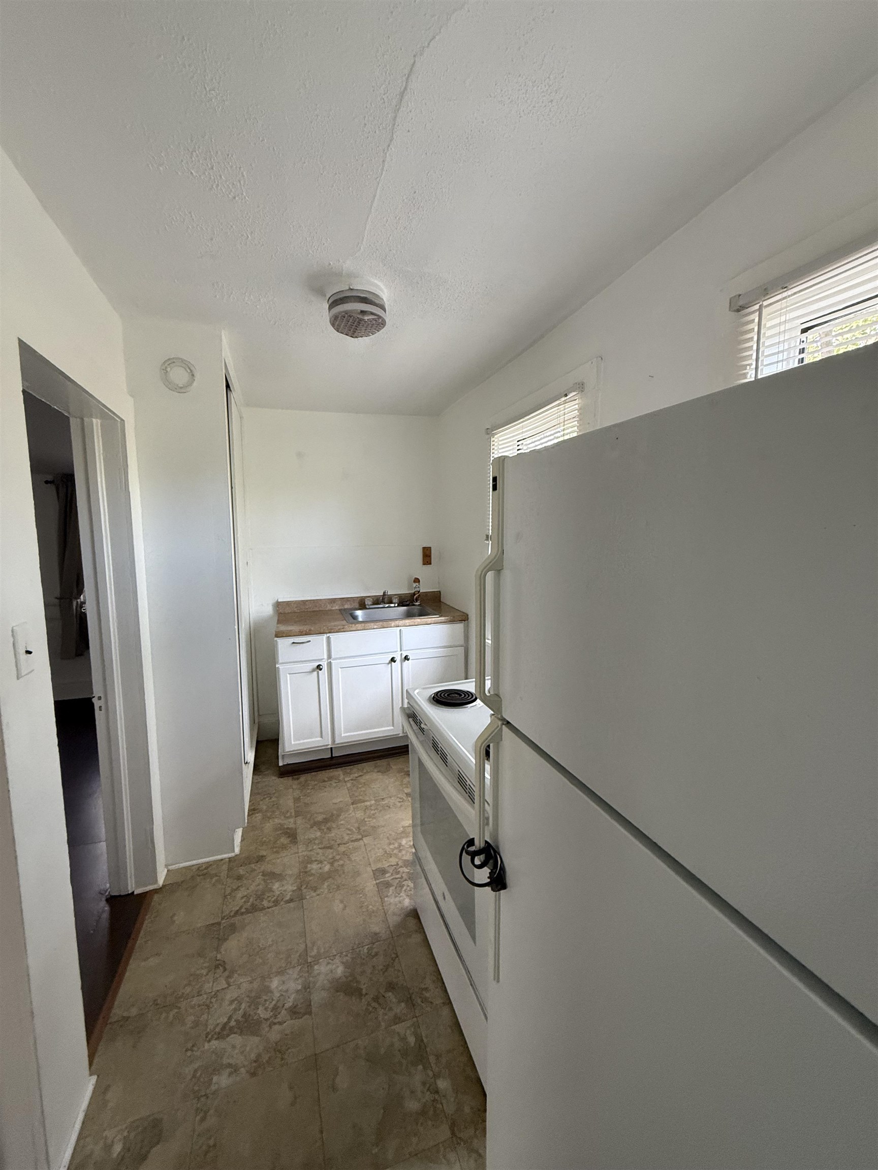 109 Bridge Street St. Augustine, FL 32084 - Photo 21 of 22 a kitchen with a refrigerator sink and stove