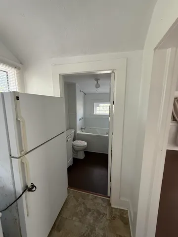 a kitchen with a refrigerator and a sink