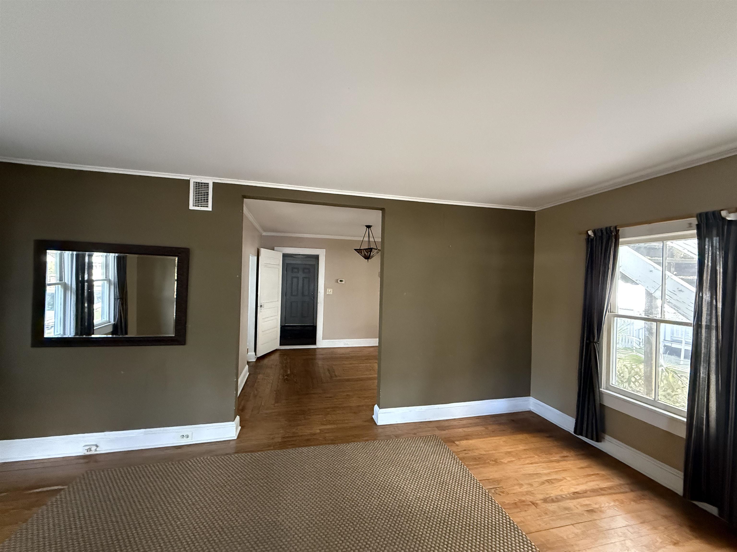 109 Bridge Street St. Augustine, FL 32084 - Photo 6 of 22 a view of an empty room with a fireplace and a window