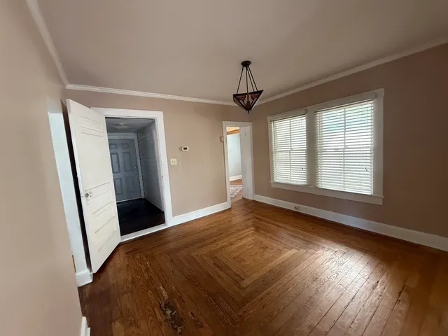 a view of empty room with window and hardwood floor