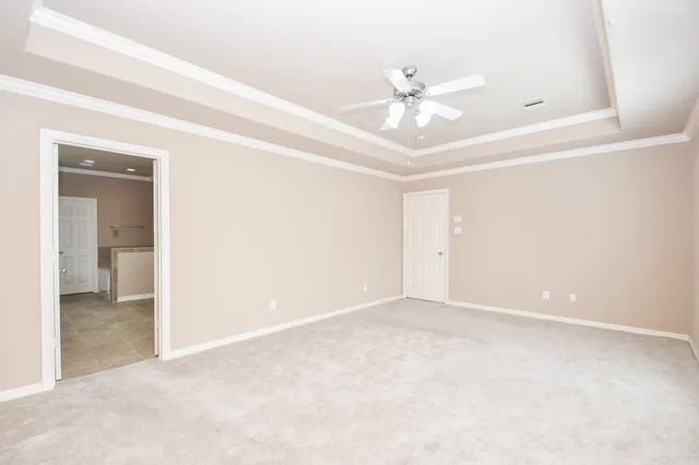 a view of an empty room with a ceiling fan