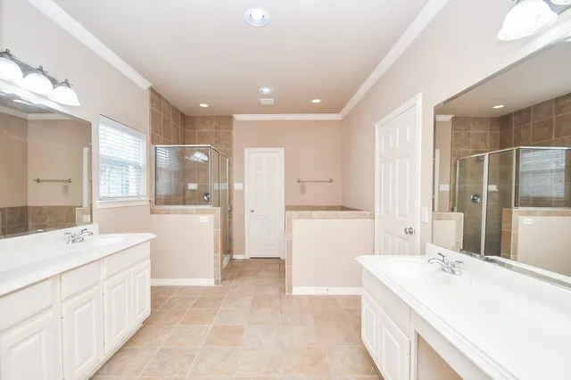 a bathroom with a sink a large mirror and a bathtub