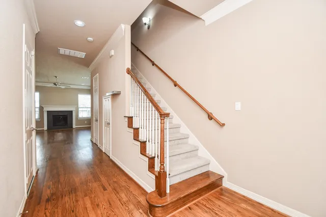 a view of entryway and hall with wooden floor