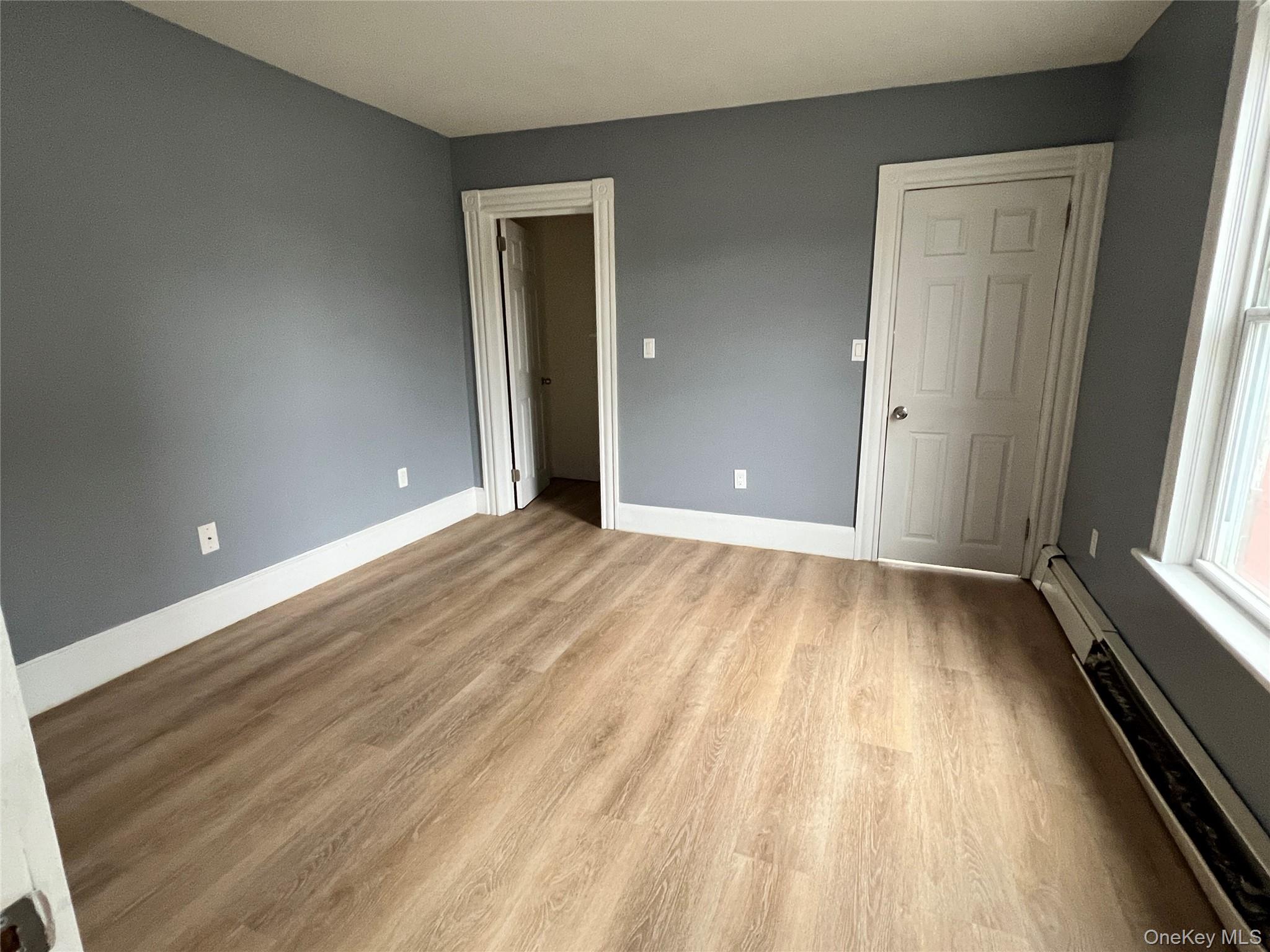 761 Main Street, Unit 2W Poughkeepsie, NY 12603 - Photo 5 of 6 a view of an empty room and window