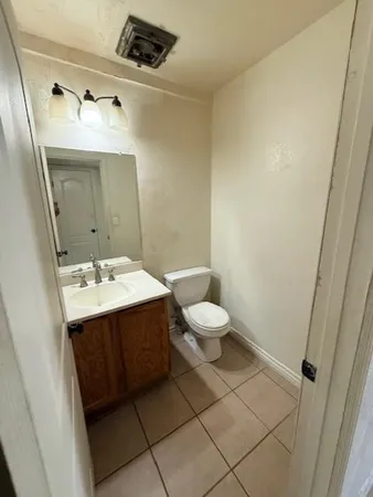 a bathroom with a sink and mirror with toilet