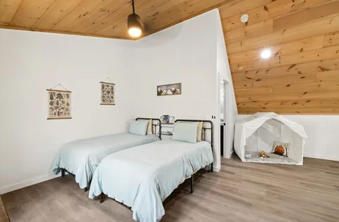 a bedroom with a bed and a window