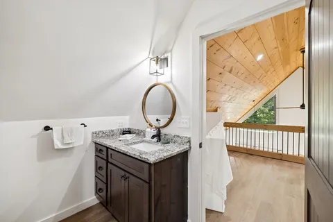 a bedroom with a bed dresser and a window