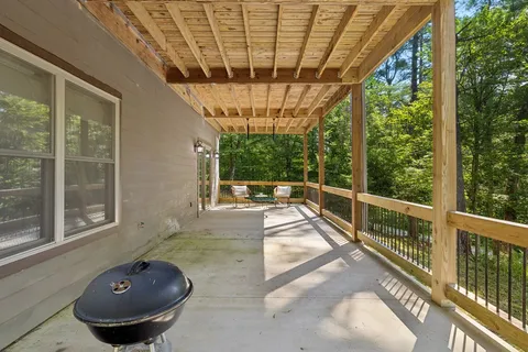 a view of a room with wooden floor and furniture