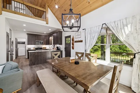 a living room with furniture a fireplace and a large window
