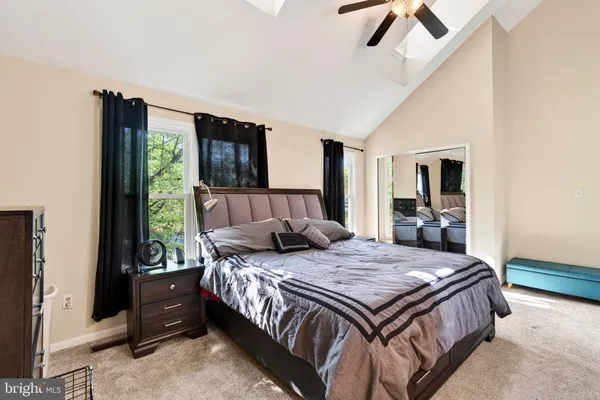 a bedroom with a large bed and a window