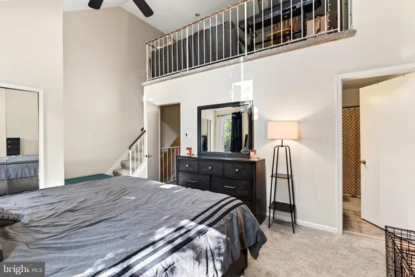 a bedroom with a bed and a refrigerator