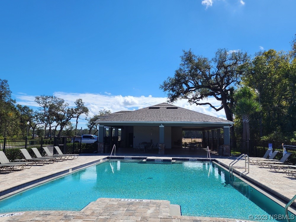 1841 Red Rock Road New Smyrna Beach, FL 32168 - Photo 20 of 22 a view of a house with swimming pool and sitting area