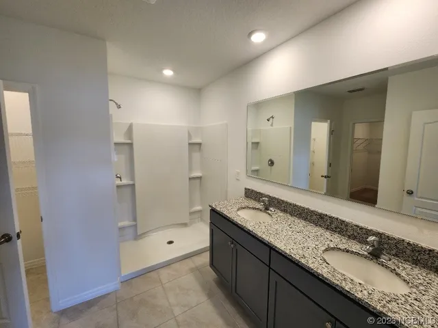 a bathroom that has a glass shower door